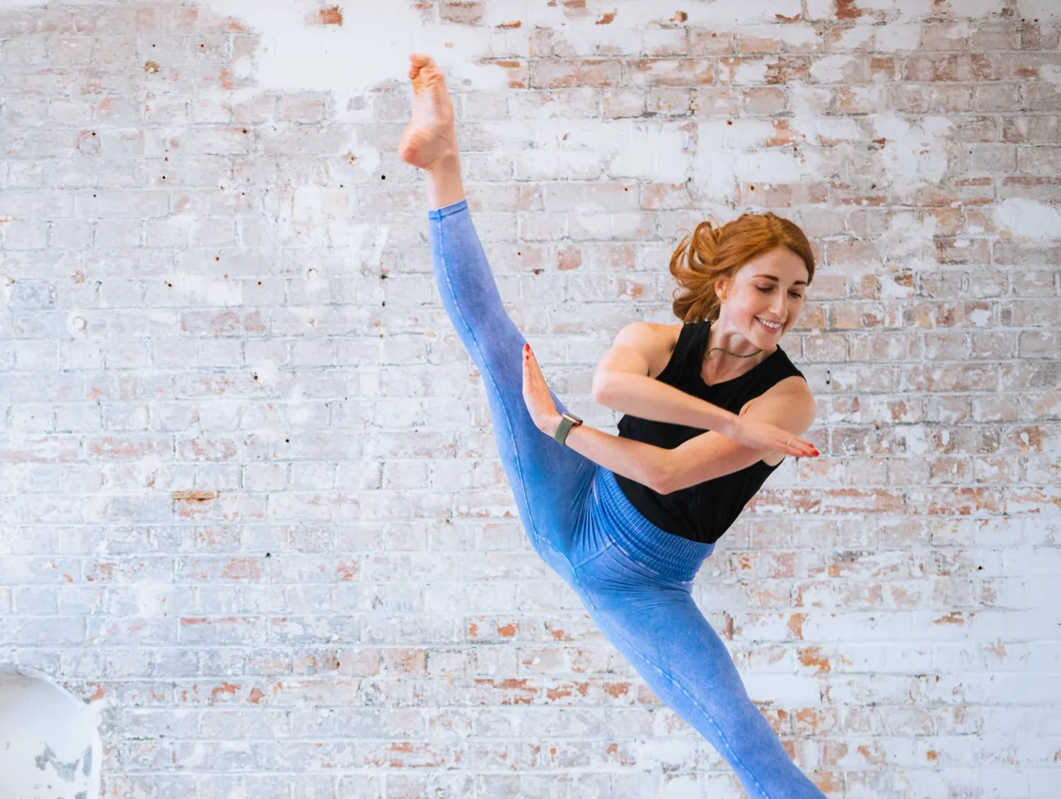 Bridget mid-leap in a split jump in the studio
