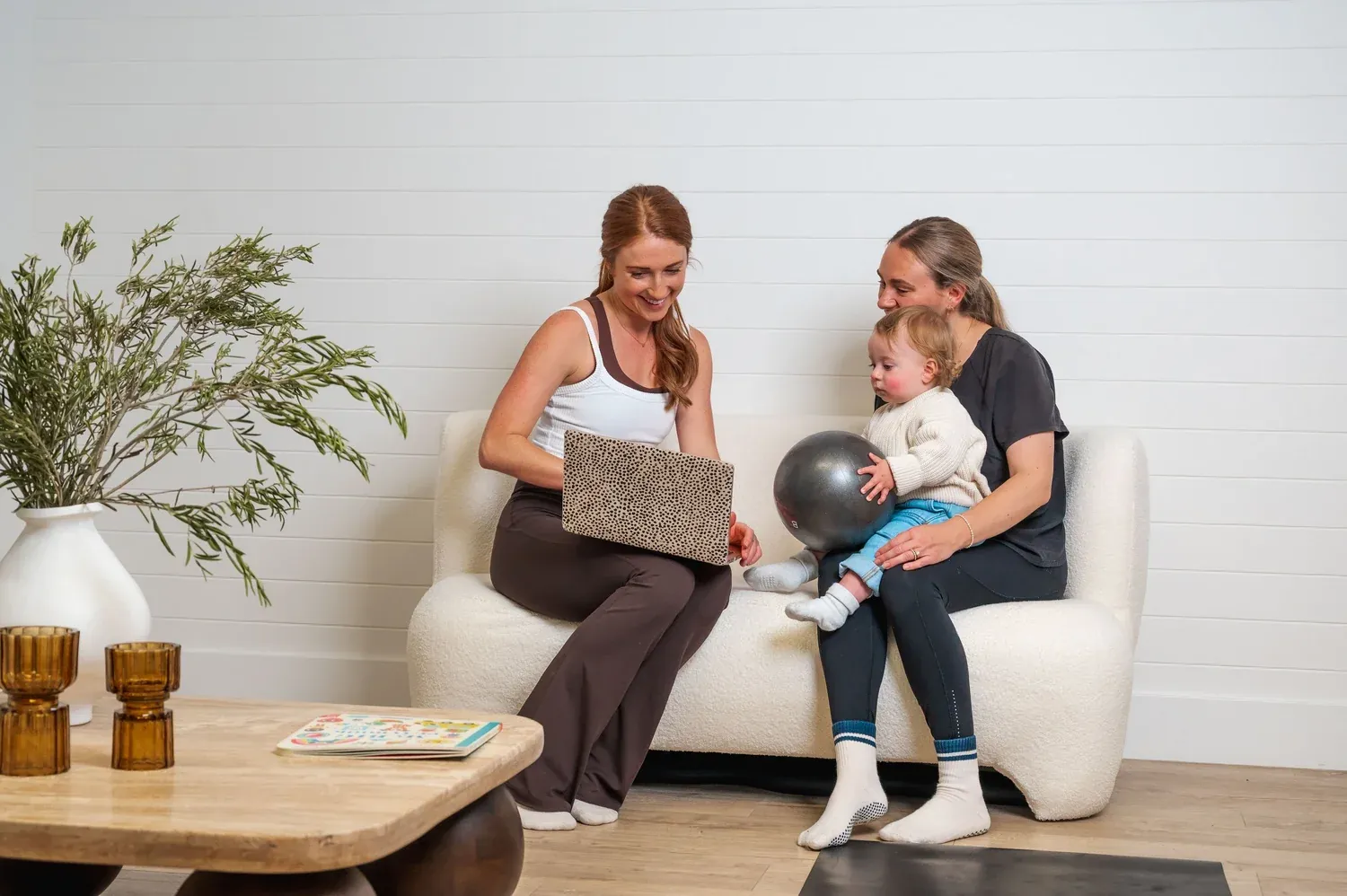 Bridget on the sofa chatting through a plan with a mum and her baby